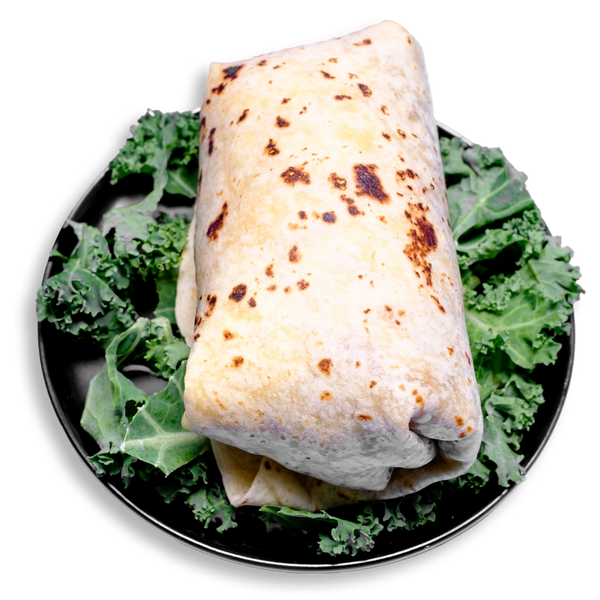 A hearty breakfast burrito wrapped in a golden, lightly toasted flour tortilla, nestled on a bed of crisp kale. This healthy prepared meal is stuffed with scrambled eggs, lean chipotle-seasoned ground turkey, melted pepper jack cheese, and diced green chiles—perfect for clean eating and convenient meal prep.