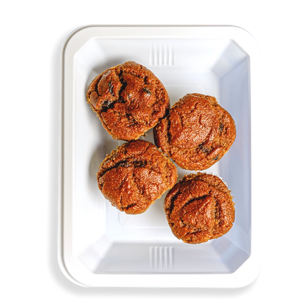 Inside a white takeout container there are four muffins that looks perfectly baked and all similar in size. This is a healthy prepared breakfast meal for people on the go who want to watch what they are eating.