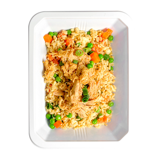This is small container loaded with a fried rice dish containing brown rice, chicken thigh, peas, carrots, and green onions. It looks like food a healthy meal prep service would cook in order to supply their customer base with healthy, flavorful food options.