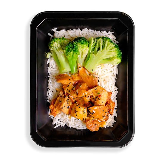 this looks like the best chinese food i have ever seen, what makes it different is that it looks so clean and healthy. broccoli stalks and orange colored chicken sit on top of a bed of white rice filling up this black togo container. everything looks clean and seasoned well making it a perfect health prepared meal for people wanting both flavor and healthy eating.