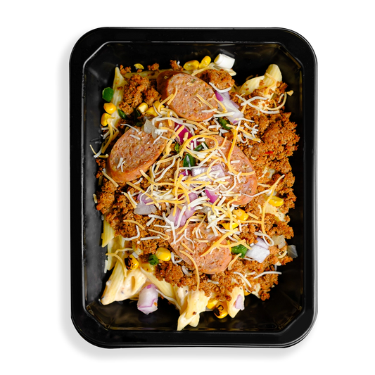 this is a container filled with tons of flavors, textures and colors. I see sausage atop ground meat as well as pasta and some mixed veggies. Shredded yellow and white cheese sits on top of all this food. This food is filling a togo container and looks like a perfect meal for someone on the go while trying to watch what they eat.