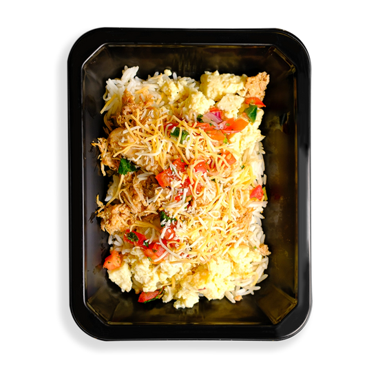 A hearty breakfast scramble with white rice, fluffy scrambled eggs, shredded chicken thighs, topped with vibrant pico de gallo and melted cheddar jack cheese, all packed in a black to-go container. This food looks like the perfect meal to start the day with and appears to be made for those who want to eat good but not spare flavor in their life.
