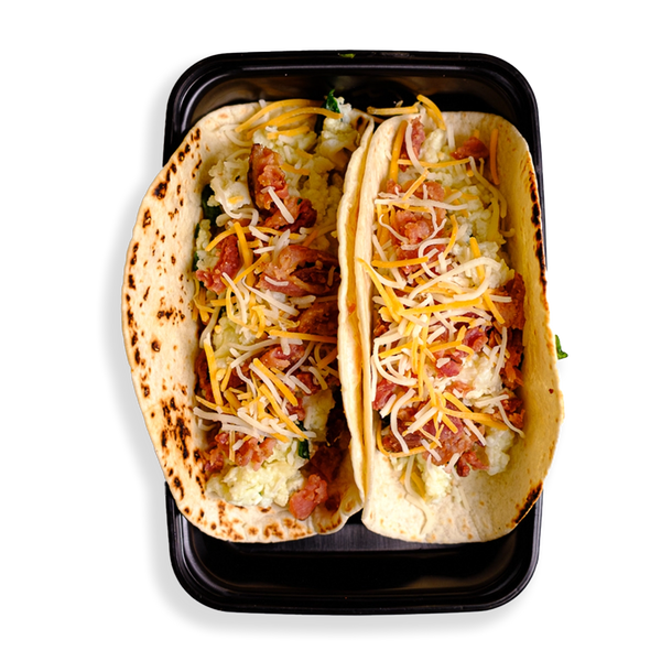 Two loaded up tacos fill this black togo container.  The tortillas are perfectly cooked and yellow and white shredded cheese sits atop fluffy eggs.  This is healthy prepared food for those looking to eat well while not depriving themselves of flavor!
