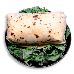 Close-up of a protein-packed breakfast burrito with a perfectly cooked tortilla showing browned toast marks, wrapped tightly around a savory mix of turkey, eggs, cheese, and green chile. Resting on a vibrant base of fresh kale, this health food meal combines energizing flavors with macro-friendly ingredients ideal for your morning meal prep routine.