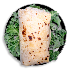 A wholesome, nutrient-dense breakfast option featuring a hand-rolled flour tortilla burrito, filled with fluffy egg whites and yolks, lean ground turkey spiced with chipotle, creamy pepper jack cheese, and green chiles. Presented on a bed of kale, this healthy meal prep favorite delivers bold flavor and balanced nutrition to start the day strong.