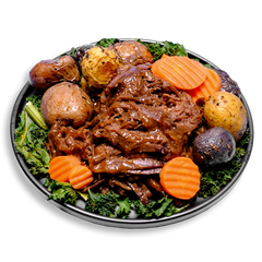 A comforting, healthy prepared meal featuring tender, slow-cooked chuck roast generously drizzled with a savory, gluten-free beef gravy. The dish is accompanied by golden roasted marble potatoes and vibrant orange carrots, all garnished with fresh, chopped kale. This balanced plate offers a high-protein, nutrient-rich option perfect for those seeking wholesome health food.