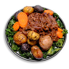 A hearty health food bowl showcasing shredded chuck roast bathed in a rich, house-made gluten-free gravy. Nestled alongside are roasted marble potatoes and sweet carrots, with a sprinkle of chopped kale adding a fresh, green touch. This healthy meal prep option combines robust flavors with balanced nutrition, ideal for fitness-focused individuals.