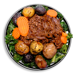 A visually appealing healthy prepared meal plate featuring succulent, slow-cooked beef chuck roast topped with a glossy, gluten-free gravy. The roast is complemented by a medley of roasted marble potatoes and tender carrots, all garnished with finely chopped kale. This dish offers a satisfying, high-protein health food experience for those mindful of their dietary choices.