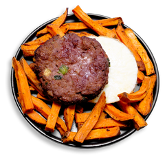 A protein-packed health food dish showcasing a juicy bison breakfast patty with visible bits of green onion and celery, resting over a fluffy egg white round. The plate is piled high with golden roasted sweet potato wedges, lightly seasoned and glistening with extra virgin olive oil. A savory, nutrient-dense option ideal for healthy meal prep or an energizing breakfast-for-dinner.