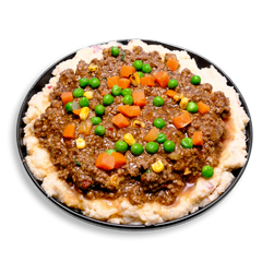 A hearty health food plate featuring creamy mashed red potatoes blended with cauliflower, topped generously with lean ground bison in a thick, savory gravy. Bright green peas, vibrant orange carrots, and golden fire-roasted corn add a colorful, nutrient-packed punch to this healthy meal prep inspired by classic British comfort food.