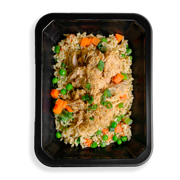 A black container is filled with a healthy version of a classic Chinese fried rice dish.  There is brown rice, chicken thigh, peas, carrots, and green onions filling this container.  The food looks very fresh and colorful.  The fact that the food is in a to-go container signals to me that this is a healthy prepared meal for delivery or pickup from a My Fit Food store location.