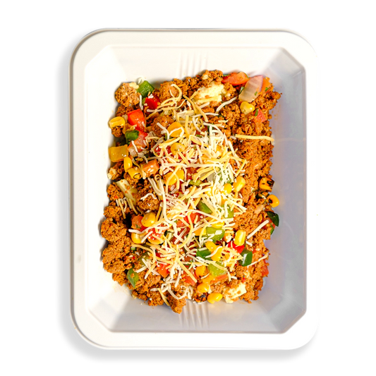 Hearty and vibrant scramble with ground turkey, egg whites, roasted veggies, and cheese—fuel for active, health-conscious lifestyles. This food fills a white togo container and appears to be for people who want to eat well while still eating clean healthy prepared foods.