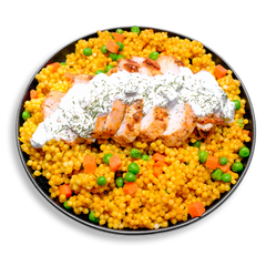 A beautifully arranged, healthy prepared meal plate showcasing a bed of saffron-hued couscous tossed with peas and carrots. Juicy, grilled Moroccan-style chicken breast slices are stacked down the center and drizzled with a luscious white sauce made from 1% Greek yogurt, dill, lemon, and a hint of Creole seasoning. Perfect for clean eating, this dish is a delicious fusion of bold taste and nutrition.