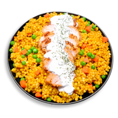 A vibrant, healthy prepared meal featuring golden couscous made from durum wheat semolina, dotted with bright green peas and orange carrot cubes. At the center, tender slices of marinated Moroccan chicken breast are layered in a neat row, generously topped with creamy 1% Greek yogurt infused with garlic, dill, and Creole spices. A wholesome, visually striking dish ideal for health-conscious meal prep with Mediterranean flair.