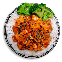 This colorful plate features juicy, bite-sized chicken thighs bathed in a glossy orange sauce infused with ginger and roasted garlic, sprinkled with nutty sesame seeds. Paired with fragrant white basmati rice and crisp-tender broccoli florets, this healthy prepared meal offers a flavorful, fitness-friendly option that supports your clean eating goals without sacrificing taste.