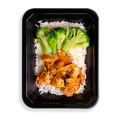 this looks like the best chinese food i have ever seen, what makes it different is that it looks so clean and healthy. broccoli stalks and orange colored chicken sit on top of a bed of white rice filling up this black togo container.  everything looks clean and seasoned well making it a perfect health prepared meal for people wanting both flavor and healthy eating.