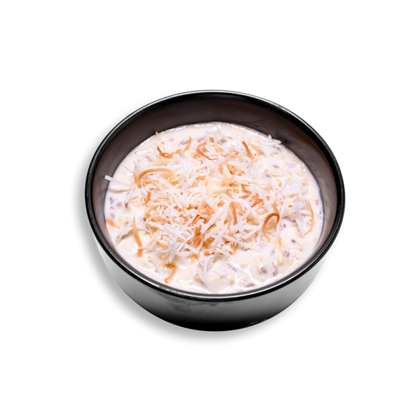 This healthy meal prep breakfast showcases a rich and creamy blend of oats, Greek yogurt, and chia seeds in a silky mixture speckled with tiny seeds and almond bits. Crowned with a colorful layer of shredded and toasted coconut flakes, the dish radiates a tropical flair. A wholesome and ready-to-eat health food perfect for fueling the day with sustained energy and clean ingredients.