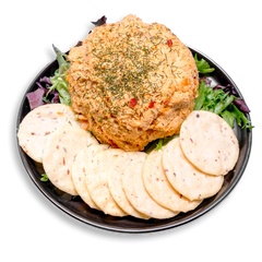 A very shapely salmon and yogurt dip sits prominently on a bed of mixed greens, topped with fresh dill for a touch of color and flavor. Light and airy gluten-free crackers made from rice flour and almonds encircle the dish, making this healthy prepared meal both visually appealing and rich in heart-healthy fats and protein.