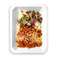 This white container is filled with what looks like the contents typically seen in a taco or burrito.  This is a healthy prepared meal designed for people focusing on their healthy but not wanting to part ways with flavorful eating.