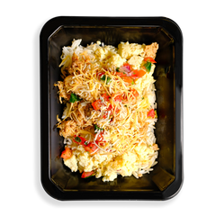A hearty breakfast scramble with white rice, fluffy scrambled eggs, shredded chicken thighs, topped with vibrant pico de gallo and melted cheddar jack cheese, all packed in a black to-go container.  This food looks like the perfect meal to start the day with and appears to be made for those who want to eat good but not spare flavor in their life.