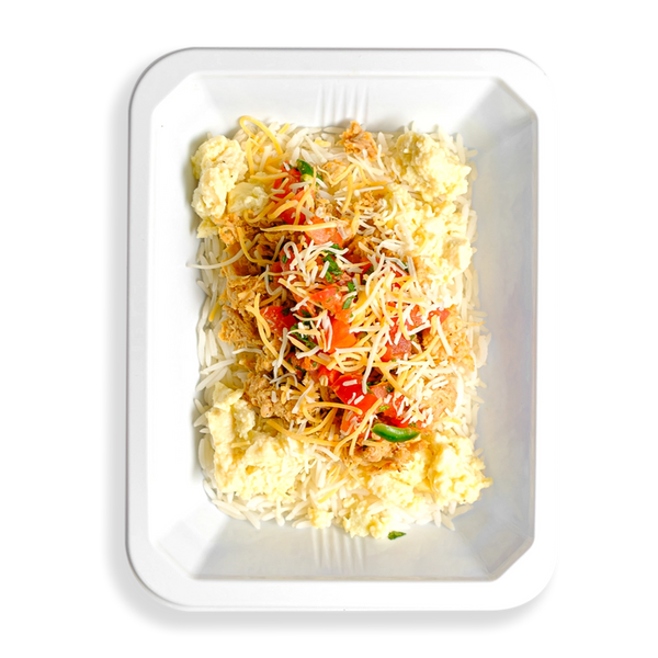 A filling breakfast scramble featuring white rice, soft scrambled eggs, and tender shredded chicken thighs, topped with fresh pico de gallo and melted cheddar jack cheese, all packed into a white to-go container. It looks like an ideal way to kick off the day—crafted for those who want satisfying, flavorful food without compromising on quality.